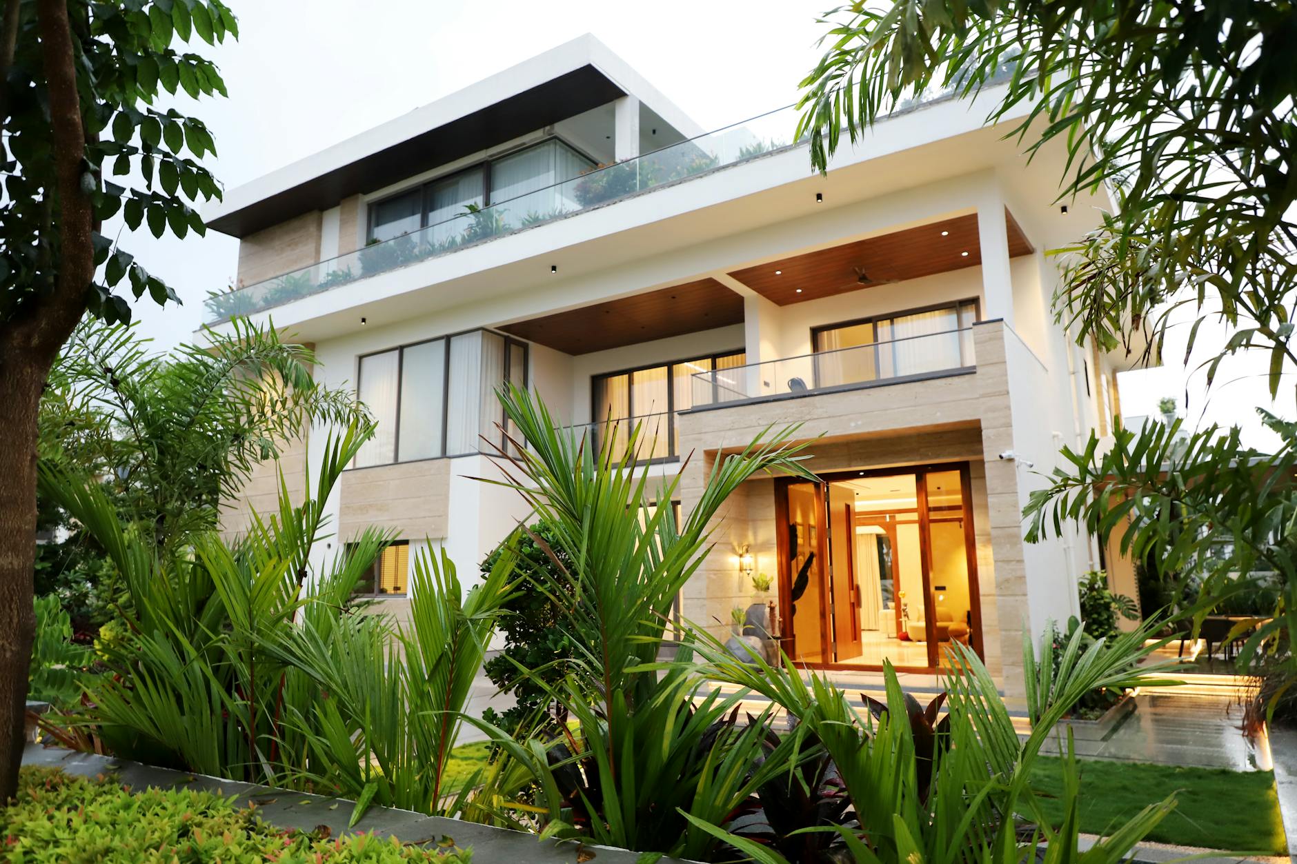 Contemporary Nigerian home at dusk with lit interiors